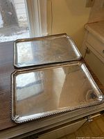 Two matching rectangular trays stacked on countertop
