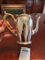 Full view front showing wood handle, spout, body and hallmark stamps