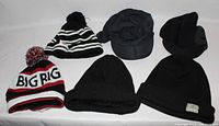 Photo of 6 various headwear items including 4 toques and 2 caps displayed on white surface.