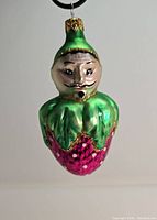 Front view showing face and detailed coloring of the ornament.