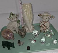 Top view of tray showing various ceramic and crystal animal figurines and a Belleek corn vase chipped at the top