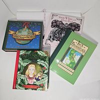 Photo of four pop-up books: Christmas Around the World, Snow White and Rose Red, The Nutcracker, and Jack and the Beanstalk, closed, showing covers.