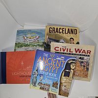 Five pop-up books stacked, showing front covers for The White House, Graceland, The Civil War, The Ancient Egypt and Lighthouses