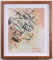 Photo of framed mixed media artwork showing abstract composition in soft colors with bold black graphic strokes and floral pattern elements, in wood frame and white mat.