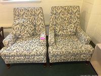 Front view of both chairs showing fabric pattern and bolster pillows