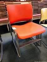 Single red chair front view showing seat and back profile