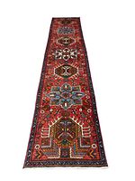 Full-length view of the red runner rug laid out on wood floor
