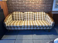 Front view of entire sofa against brick wall