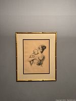 Full view of framed lithograph on wall, showing gold-tone bamboo-style frame and double mat