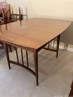 Rectangular walnut dining table on curved trestle base