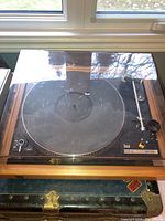 Front view of Dual 505-2 turntable with closed dust cover showing wood veneer plinth and platter mat
