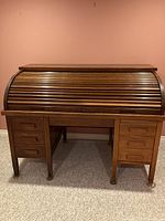 Front exterior view with tambour top closed showing wood finish and drawer layout