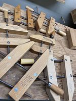 Overview of six wooden handscrew clamps, including Jorgensen and Brink & Cotton brands, displayed on a wooden surface.