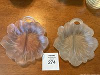 A top-down view of both the pink and white twin 8 depression glass candy or snack dishes showing their tree design and distinct colors.