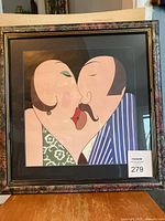 Framed lithograph artwork showing a stylized man and woman kissing, with clear view of colors and frame style.