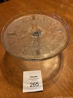 Top view showing the textured harp design and gold ruffled edge on the crystal cake stand surface.