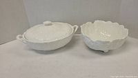 Shows both cabbage serveware pieces side by side: casserole dish with lid and cabbage bowl.