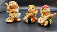 Group view of all three Pendelfin rabbit figurines holding instruments, showing colors and poses.