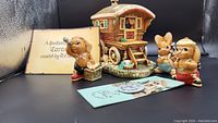 Overall view of the Caravan figurine with three animal figurines and Pendelfin Caravan exclusive certificate