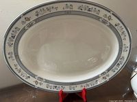 Close-up of large oval platter showing the floral blue and gold patterned border.