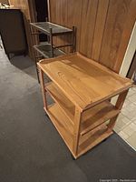 Wood veneer computer desk on wheels with three shelves in light wood finish