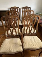 Six vintage solid wood dining chairs with carved backs, beige cushioned seats needing reupholstering