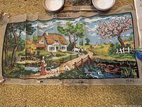 Needlepoint canvas of a cottage by river scene