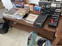 Overview of the collection showing vinyl records, cassette tapes, cassette player, and large music box on a wooden table.