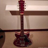 Full front view showing headstock with Silvertone logo, neck, body and hardware