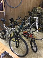 Five bikes stacked together in a room showing different bike types and sizes.