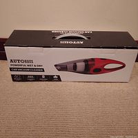 Front view of the Autohaus car vacuum cleaner box showing product image and features.