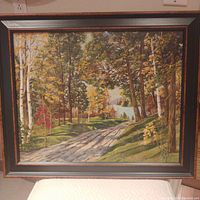 Frontal view of the oil painting 'The Forest' in its frame, showing the forest landscape with a pathway and distant water.