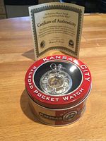 Photo showing the collectible tin container and certificate of authenticity.
