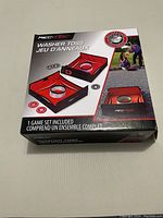 Box front showing REK-TEK Washer Toss Game set with images of two angled targets with center holes and washers for playing, and people playing outdoors.