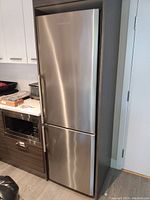 Full view of stainless steel Blomberg fridge installed in kitchen cabinet