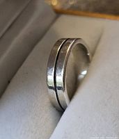 Close-up photo of sterling silver ring showing polished finish, recessed groove and 'Mexico 925' stamp on inner band.