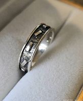 Close-up front view of the silver ring showing geometric rectangular pattern and oxidized detail