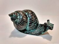 Clear photo presenting the snail figurine's form, texture, and color for accurate condition and material assessment.