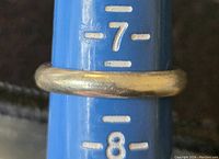 Ring on sizing mandrel showing size and smooth rounded design.