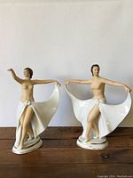 Pair of porcelain Dresden dancers displayed side by side showing overall size and form.