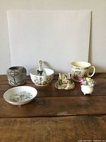 Photo showing six assorted vintage china and ceramic items arranged on wooden surface