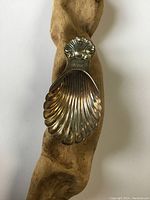 Top view of Birks sterling silver spoon shaped like a scallop shell, showing spoon shape and design details