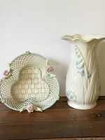 Vase and basket shown side by side on wood surface against white background