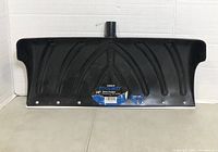 Photo of 24-inch black Toolway snow pusher shovel with label showing product details.