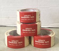 Four rolls of utility masking tape, each labeled 48mm x 55m / 1.89in x 60yds, stacked in two rows with two rolls on bottom and two rolls on top.