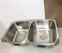 Front angled view of the Kohler stainless steel double-bowl kitchen sink showing the two bowls and rim.