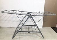 Clothes drying rack, showing full front and side view detailing wing-style rods and foldable frame