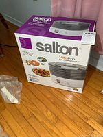 Original packaging box of Salton VitaPro food dehydrator and plastic bag with some components.