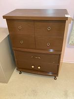 Front view of vintage 4 drawer hiboy dresser showing drawer pulls and overall condition