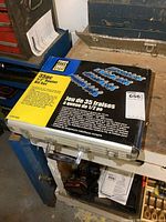 Closed metal storage case of Power Fist 35pc 1/2 inch router bit set with seller label number 656 and visible shelf wear and corner damage.